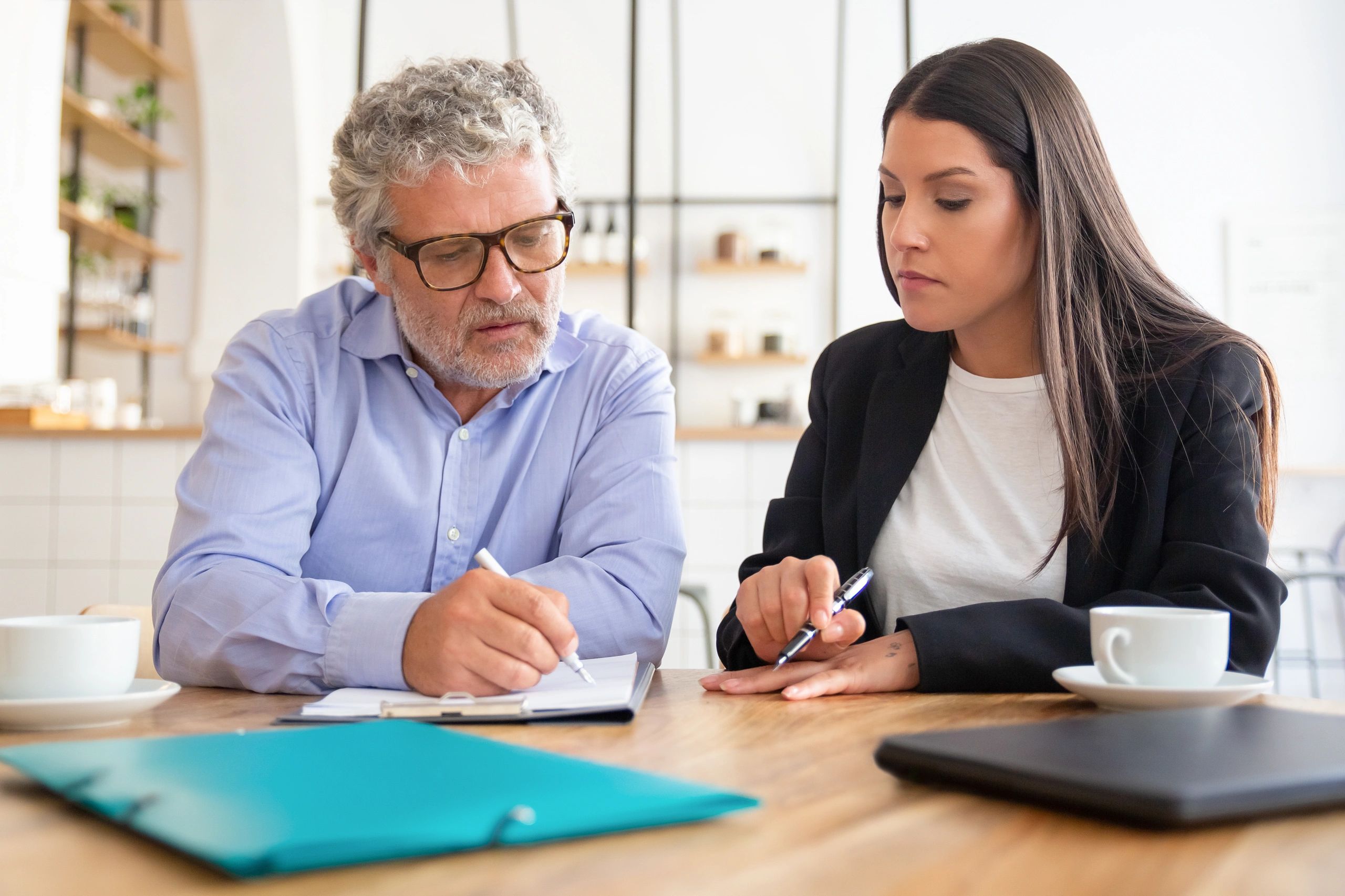 Attorney reviewing documents with a client during a consultation